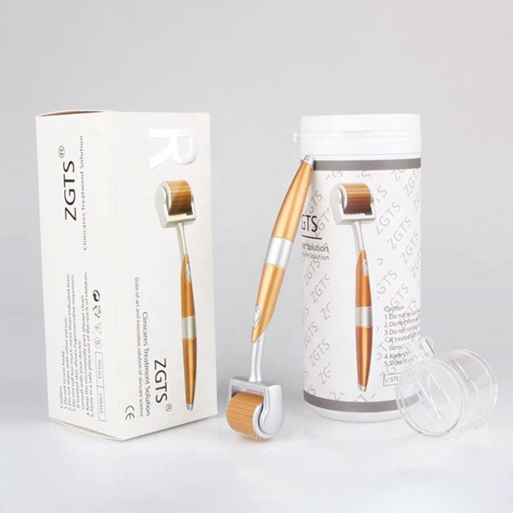 Gold and white derma roller with packaging box and cylindrical case on a light background.