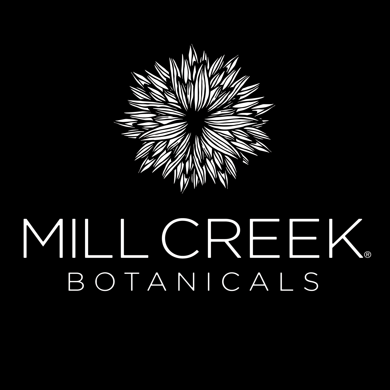 Mill Creek Botanicals logo with a stylized floral graphic on a black background.
