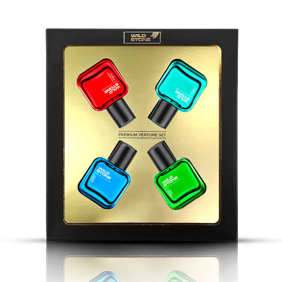 Four colorful perfume bottles in a square black and gold gift box.