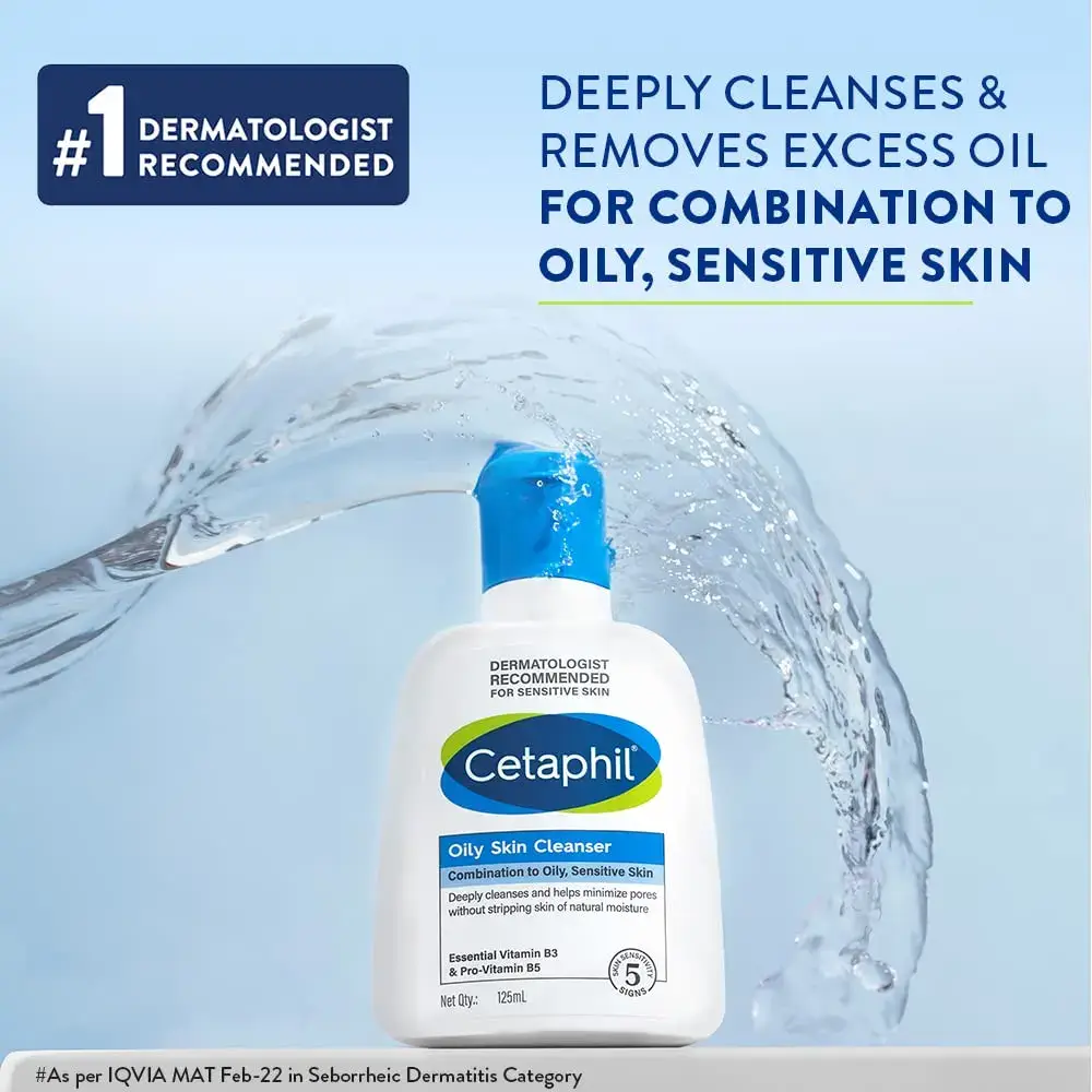 Cetaphil cleanser bottle with a splash of water against a light blue background.