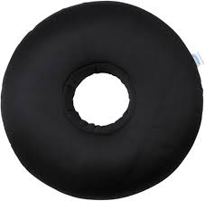 Black donut-shaped cushion with a hole in the center.