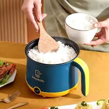 Person serving rice from a blue and yellow electric rice cooker into a bowl.