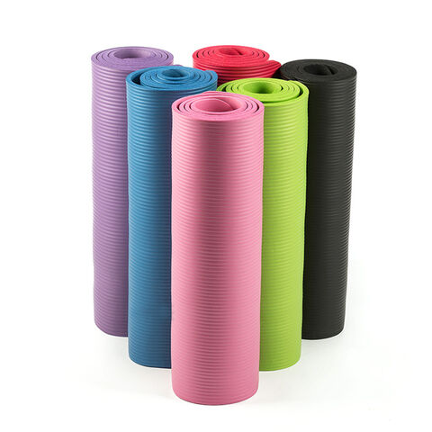 Six rolled yoga mats in purple, blue, pink, green, red, and black standing upright.
