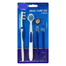 Oral care kit with toothbrush, dental mirror, pick, and scraper in blue packaging.