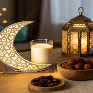 Lit crescent moon decor, lantern, glass of milk, and bowls of dates on a wooden table.