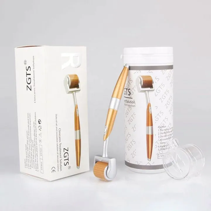 Gold and white derma roller with packaging box and cylindrical case on a light background.