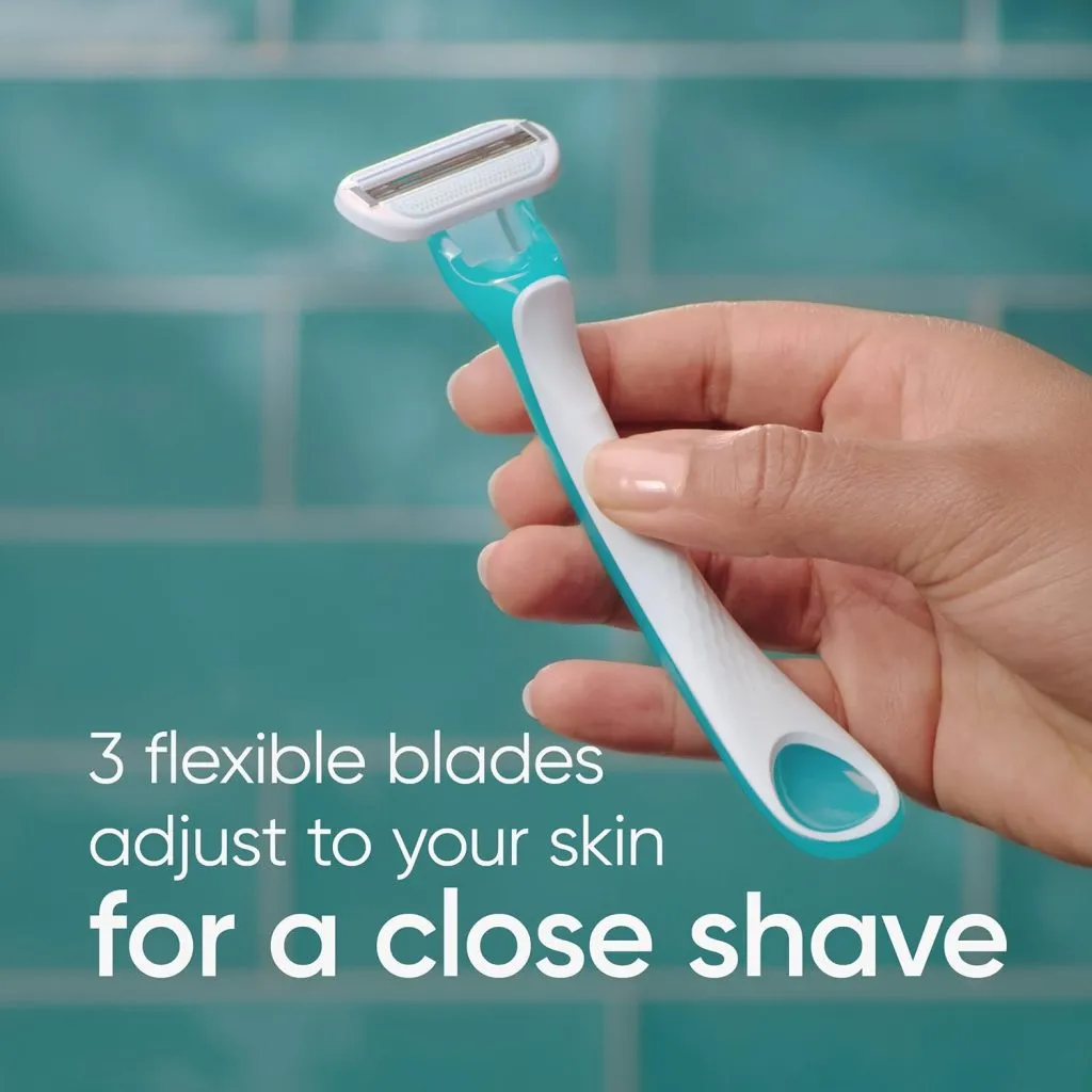 Hand holding a teal and white razor in front of blue tiled background.