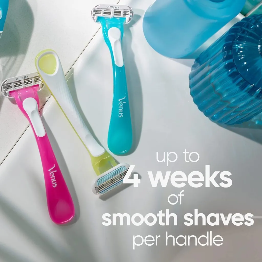 Three colorful Venus razors on a bright surface next to translucent blue objects.