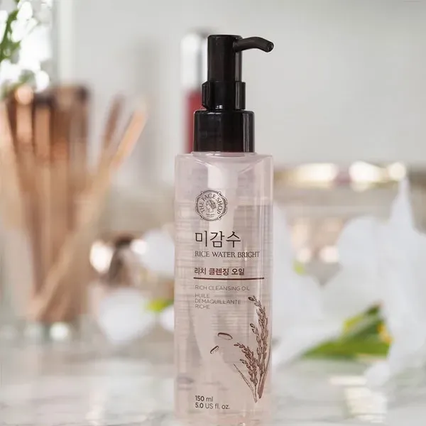 Clear plastic pump bottle with Korean text on a bathroom counter, soft background.