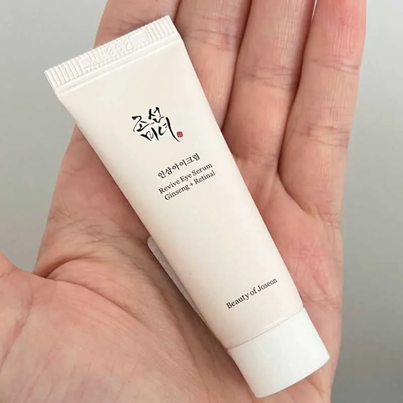 A small Beauty of Joseon skincare tube held in a person's palm.