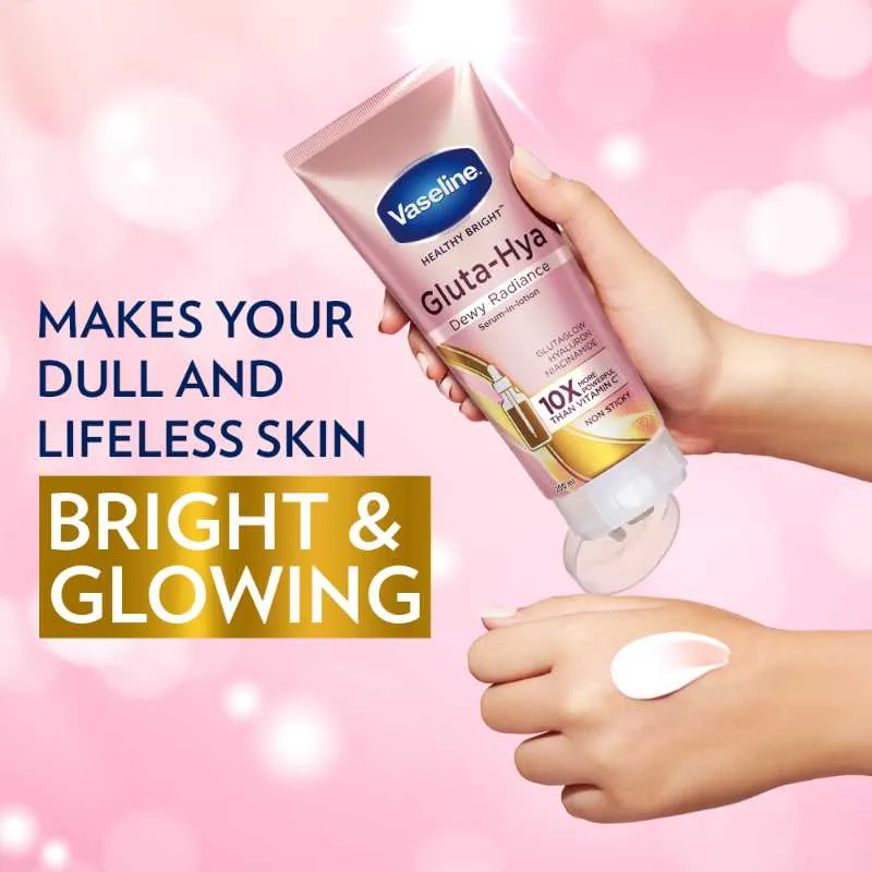 Hand holding Vaseline Gluta-Hya lotion tube with cream applied on the back of the other hand.