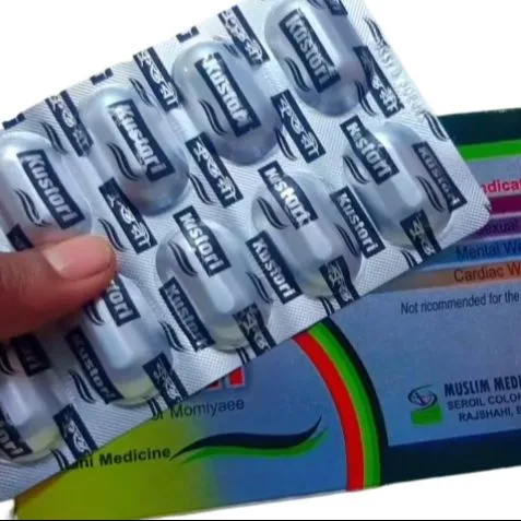 Hand holding a blister pack of tablets in front of colorful medicine packaging.