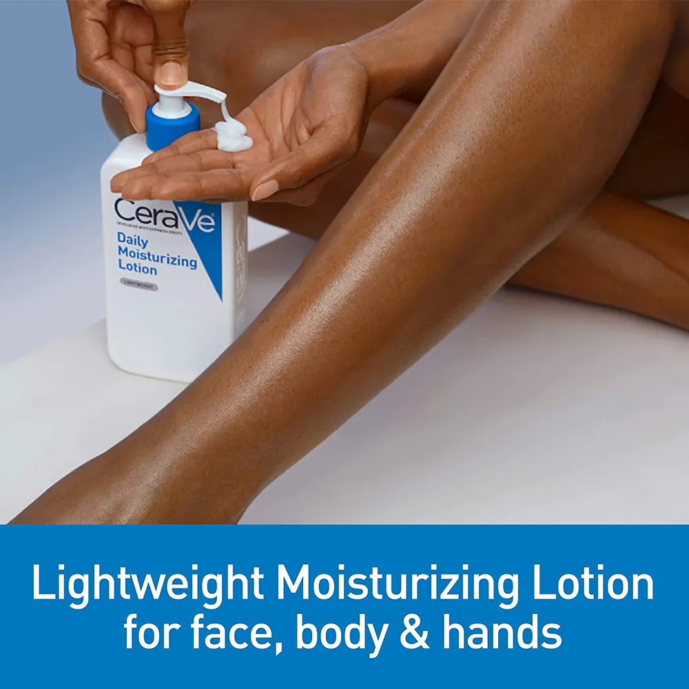 Person applying lotion to leg from a Cerave bottle on a white surface.