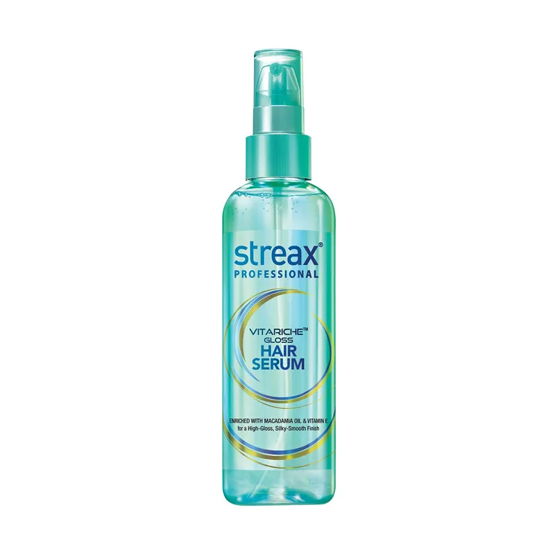 Clear bottle of Streax Professional hair serum with a green pump cap.