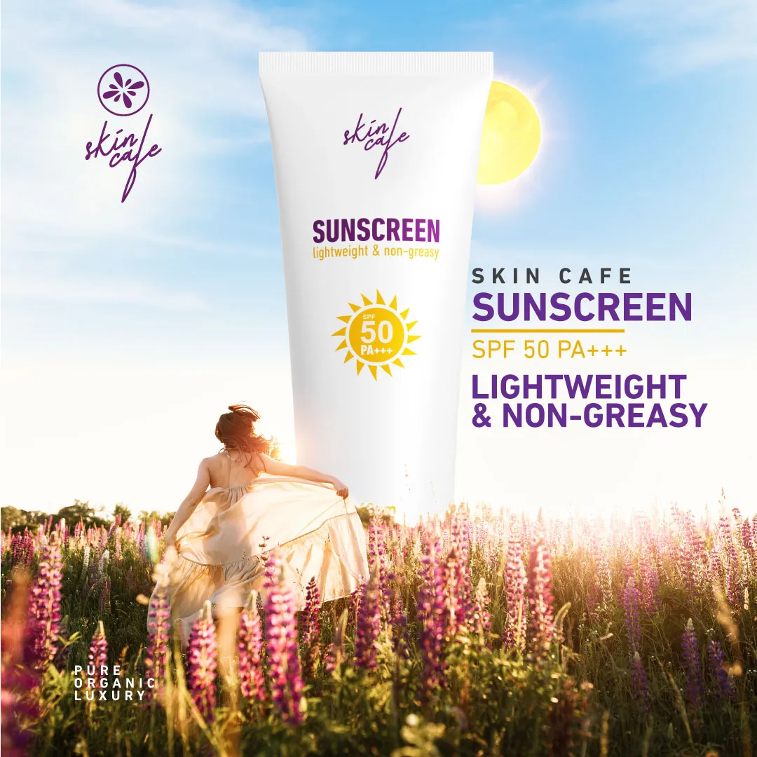 A sunscreen tube above a field of flowers with a woman walking outdoors in sunlight.