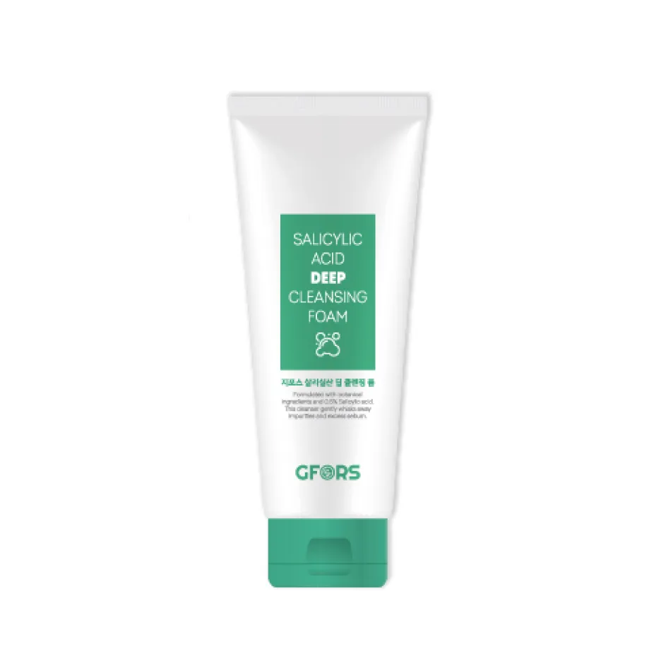 White tube of cleansing foam with green label and cap on a plain background.