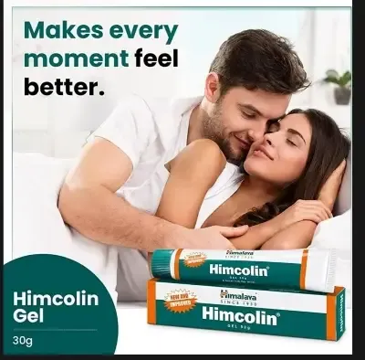 Couple embracing on a bed with Himcolin Gel packaging in the foreground.
