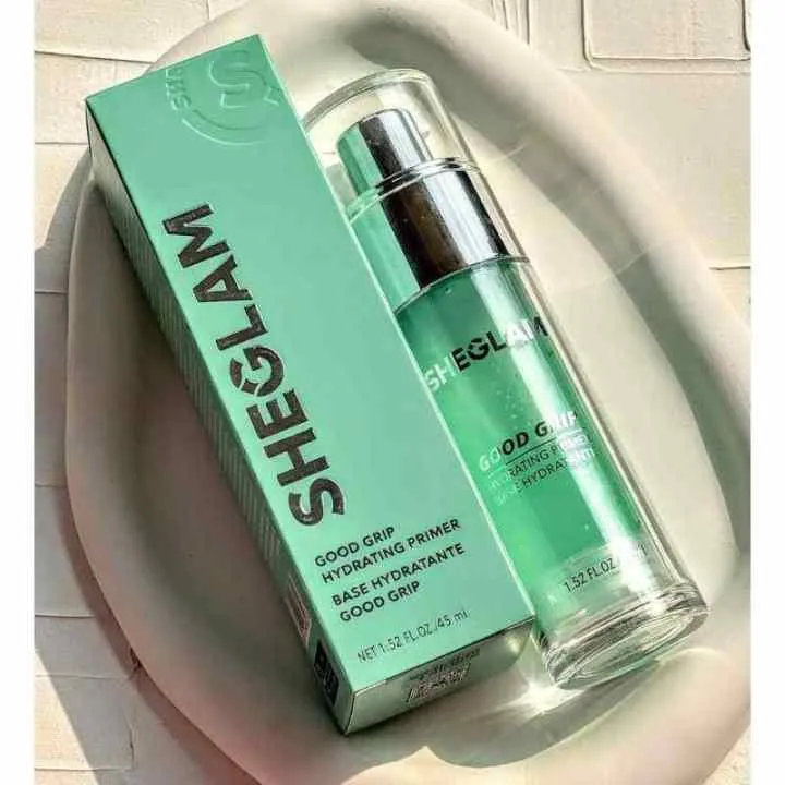 Sheglam green skincare product and matching box on a white dish in sunlight.