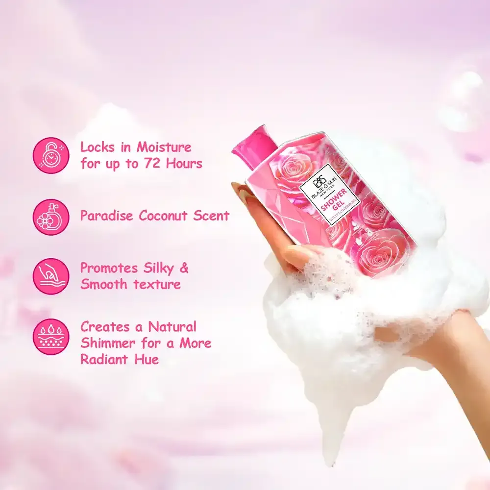 Hand holding a pink floral bottle of body wash surrounded by white foam against a pink background.