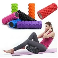 Woman using a textured foam roller on her leg, with various colored rollers nearby.