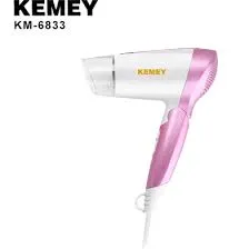 Pink and white Kemey KM-6833 hair dryer on a white background.