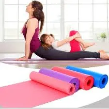 Woman and child doing yoga on mats, with rolled mats in pink, purple, red, and blue nearby.