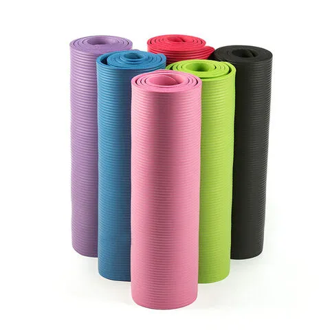 Six rolled yoga mats in purple, blue, pink, green, red, and black arranged upright.