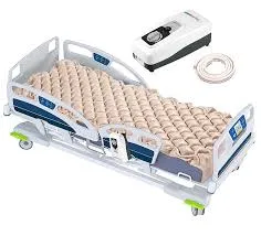 Hospital bed with an air mattress and a portable air pump placed beside it.