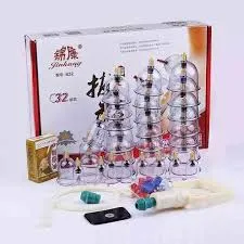 Cupping therapy set with clear cups, accessories, and packaging box in the background.