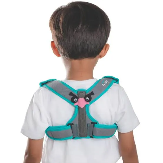 Child wearing a turquoise and gray posture corrector harness over a white shirt.