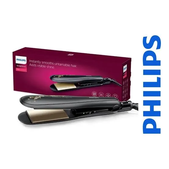 Philips BHS736 hair straightener in matte black with wide gold ceramic plates, shown next to its maroon product box featuring the text "Instantly smoothes untamable hair. Adds visible shine.