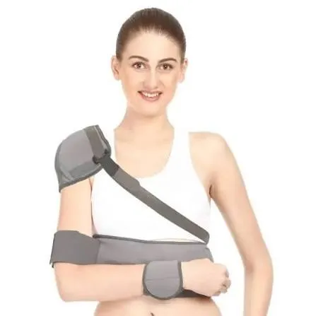 Woman wearing an arm and shoulder immobilizer brace, smiling against a white background.