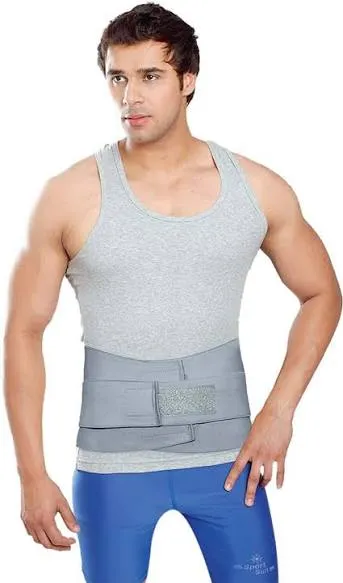 Man wearing a grey abdominal support belt over a tank top and blue pants.